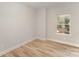 Cozy bedroom with wood-look floors and a bright window at 2825 New Pineola Rd # 7A, Charlotte, NC 28208