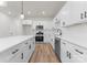 Bright kitchen features white cabinets, stainless steel appliances, subway tile backsplash, and a large kitchen island at 2825 New Pineola Rd # 7A, Charlotte, NC 28208