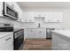 Modern kitchen featuring stainless steel appliances, white cabinetry, matte black hardware, and subway tile backsplash at 2825 New Pineola Rd # 7A, Charlotte, NC 28208