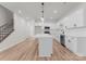 Open floor plan featuring kitchen with white cabinetry, stainless steel appliances, subway tile backsplash and kitchen island at 2825 New Pineola Rd # 7A, Charlotte, NC 28208