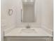 Modern powder room featuring a marble countertop vanity with a square mirror and brushed nickel faucet at 2825 New Pineola Rd # 7A, Charlotte, NC 28208