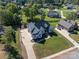 Aerial view of landscaped yard, mature trees, driveway and beautifully designed home at 329 Wintergreen Ct, Kings Mountain, NC 28086