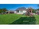 Spacious backyard with a simulated lawn, a playset, patio and fenced perimeter at 329 Wintergreen Ct, Kings Mountain, NC 28086