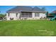 Spacious backyard with a lush green lawn, a patio, and a play area for outdoor enjoyment at 329 Wintergreen Ct, Kings Mountain, NC 28086
