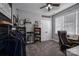 Comfortable bedroom featuring neutral walls, ceiling fan, double doors, and shelving units for storage or display at 329 Wintergreen Ct, Kings Mountain, NC 28086