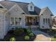 Close-up of a brick home, featuring an inviting front porch with charming entryway and seating at 329 Wintergreen Ct, Kings Mountain, NC 28086