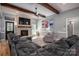 Cozy living room with a brick fireplace, large sectional sofa, and hardwood floors, ideal for Gathering gatherings at 329 Wintergreen Ct, Kings Mountain, NC 28086