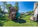 Beautiful shot of a fun backyard playground with a green slide, climbing areas, and other play structures at 329 Wintergreen Ct, Kings Mountain, NC 28086