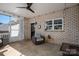 Charming porch with brick walls, a ceiling fan, a comfortable chair, and view of the backyard at 329 Wintergreen Ct, Kings Mountain, NC 28086
