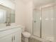 Bright bathroom with white vanity, glass shower, and modern fixtures at 3928 Craig Ave, Charlotte, NC 28211