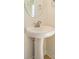 Bathroom featuring a pedestal sink and a round mirror at 3928 Craig Ave, Charlotte, NC 28211