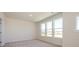 Bedroom with carpeted floors and lots of light from a large set of windows at 3928 Craig Ave, Charlotte, NC 28211