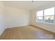 Spacious bedroom with hardwood floors, neutral walls, and a large window overlooking the community at 3928 Craig Ave, Charlotte, NC 28211