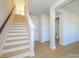 Open hallway featuring a staircase, hardwood floors, and access to a half bathroom at 3928 Craig Ave, Charlotte, NC 28211