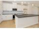 Modern kitchen featuring a central island, sleek countertops, stainless steel appliances, and stylish pendant lights at 3928 Craig Ave, Charlotte, NC 28211