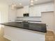 Open kitchen with hardwood floors, white cabinets, stainless steel appliances, and a central island at 3928 Craig Ave, Charlotte, NC 28211