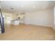 Open-concept living area with kitchen, lots of light and hardwood flooring at 3928 Craig Ave, Charlotte, NC 28211