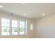 Living area featuring large windows and recessed lighting for optimal brightness at 3928 Craig Ave, Charlotte, NC 28211
