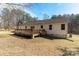 Backyard with a wooden deck, showcasing outdoor living with a well-maintained lawn at 4175 Barnell Ln, Maiden, NC 28650
