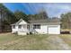 Charming one-story home with white siding, attached garage, and front porch in a wooded setting at 4175 Barnell Ln, Maiden, NC 28650