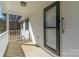 Cozy covered front porch with secure black-framed glass door and white railings at 4175 Barnell Ln, Maiden, NC 28650