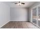 Spacious living room with vinyl plank flooring, ceiling fan, and access to outdoor deck at 4175 Barnell Ln, Maiden, NC 28650