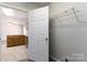 Mudroom view showcasing neutral walls, an open door, and a wire storage shelf above the baseboard trim at 4175 Barnell Ln, Maiden, NC 28650