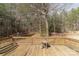 View of a backyard wooden deck surrounded by forest, offering a tranquil outdoor living space at 4175 Barnell Ln, Maiden, NC 28650