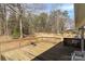 Backyard wooden deck overlooking a serene, wooded area providing a cozy outdoor space with seating at 4175 Barnell Ln, Maiden, NC 28650
