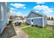 Landscaped backyard with a detached garage and patio set is perfect for entertaining guests at 431 Third Baxter St, Fort Mill, SC 29708