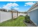 Relaxing backyard featuring a porch swing, landscaping, and a white picket fence at 431 Third Baxter St, Fort Mill, SC 29708