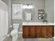 Well-lit bathroom features a vanity with wooden cabinets and a decorative framed mirror at 431 Third Baxter St, Fort Mill, SC 29708