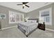 Inviting bedroom with a gray upholstered bed, soft lighting, and a ceiling fan at 431 Third Baxter St, Fort Mill, SC 29708