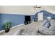 Spacious bonus room with blue accent walls, ceiling fan, TV, and comfortable seating at 431 Third Baxter St, Fort Mill, SC 29708
