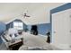 Bonus room features blue accent walls, ceiling fan, television, and comfortable seating at 431 Third Baxter St, Fort Mill, SC 29708