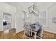 This dining area features beautiful lighting fixture, wood floors, and multiple windows at 431 Third Baxter St, Fort Mill, SC 29708