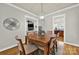 Open dining room adjacent to living area and kitchen, featuring hardwood floors and modern lighting at 431 Third Baxter St, Fort Mill, SC 29708