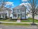 Charming blue two-story home featuring a welcoming porch, manicured lawn, and a yellow front door at 431 Third Baxter St, Fort Mill, SC 29708