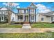 Charming two-story home with a front porch, yellow door, manicured landscaping, and inviting curb appeal at 431 Third Baxter St, Fort Mill, SC 29708
