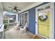 Inviting front porch with rocking chairs, a ceiling fan, and a sunny yellow front door at 431 Third Baxter St, Fort Mill, SC 29708
