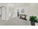 Bright hallway featuring a decorative table with floral arrangement and neutral carpeting at 431 Third Baxter St, Fort Mill, SC 29708