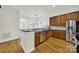 Open kitchen with wood cabinets, granite countertops, and stainless steel appliances at 431 Third Baxter St, Fort Mill, SC 29708