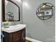 This powder room features a sleek vanity and stylish decorative shelving and mirror at 431 Third Baxter St, Fort Mill, SC 29708