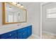 Bathroom with blue cabinets and a large framed mirror at 4511 Briarcreek Rd, Maiden, NC 28650