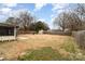 Spacious backyard with a shed and covered patio, enclosed by a wooden fence at 4815 Carriage Drive Cir, Charlotte, NC 28205