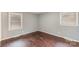 Neutral bedroom with wood flooring and natural light from two windows at 4815 Carriage Drive Cir, Charlotte, NC 28205