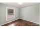 Cozy bedroom with hardwood floors and a large window at 4815 Carriage Drive Cir, Charlotte, NC 28205