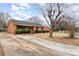 A charming single-story brick home with a long drive and a neatly kept lawn at 4815 Carriage Drive Cir, Charlotte, NC 28205