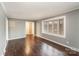 Bright living room with hardwood floors and large window at 4815 Carriage Drive Cir, Charlotte, NC 28205