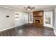 Inviting living room with a red brick fireplace and dark hardwood floors at 4815 Carriage Drive Cir, Charlotte, NC 28205
